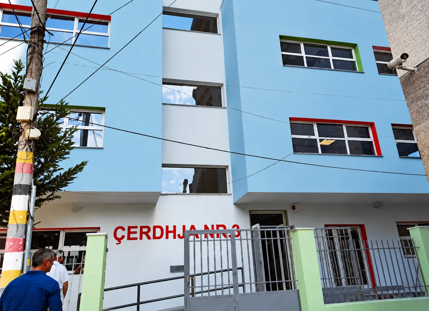 Facade of Çerdhja Nr. 3 with colorful trim around the windows